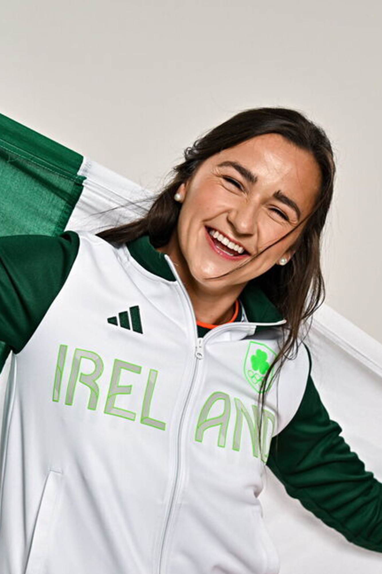 Phil Healy laughing, wrapped in the Irish flag